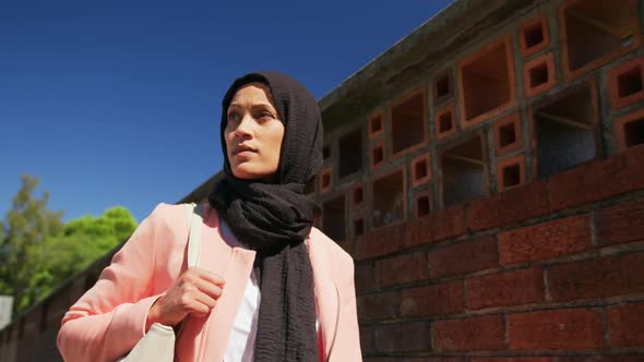 Young woman wearing hijab out and about in the city