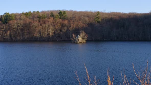 Isolated old structure on Tarrytown Lakes waters, New York. Aerial forward low speed