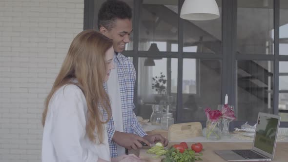 Portrait Happy Interracial Couple Preparing Breakfast or Lunch in a Beautiful Modern Kitchen