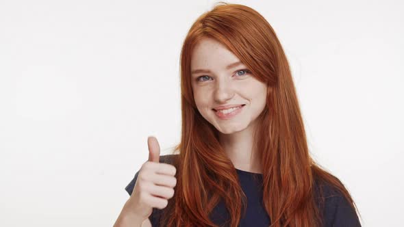 Smiling Charming Foxy Caucasian Teenage Girl Showing Ok with One Thumb on White Background in