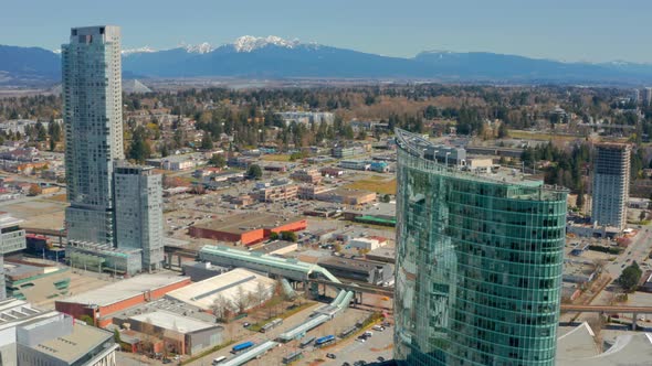 Drone Orbits a Train Station in a Stunning Mountainside City in Canada. Surrey Central Station in th
