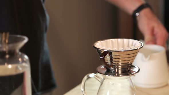 Handheld Close-up of Barista Makes Hand Brew Coffee