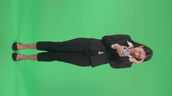 Full Body Of Asian Business Woman Having Headache While Using Mobile Phone In The Green Screen