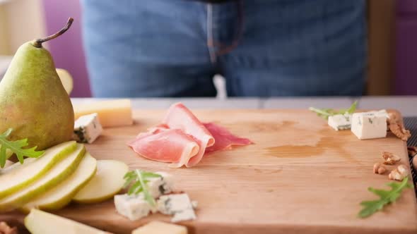 Making Pear and Blue Cheese Salad  Slices of Jamon