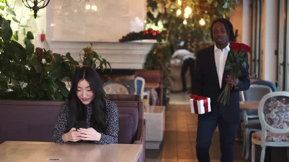 African Man Making Surprise for His Girlfriend on Valentine's Day at Restaurant