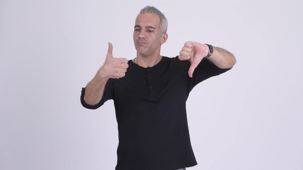 Confused Persian Man Making Decision Against White Background