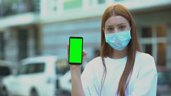 Girl in Sick Mask Holding Green Screen Phone, Appointment With Doctor Online