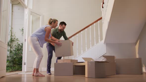 Caucasian attractive couple moving into new house