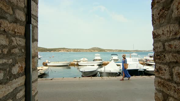 Young traveler on the pier in Sibenik, Croatia. Slow motion