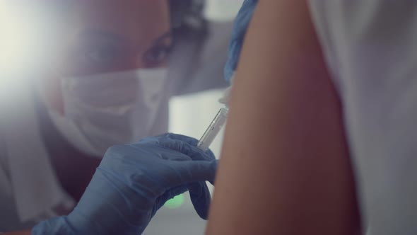 Face Woman Doctor Making Vaccine Injection to Patient Visiting Hospital Close Up