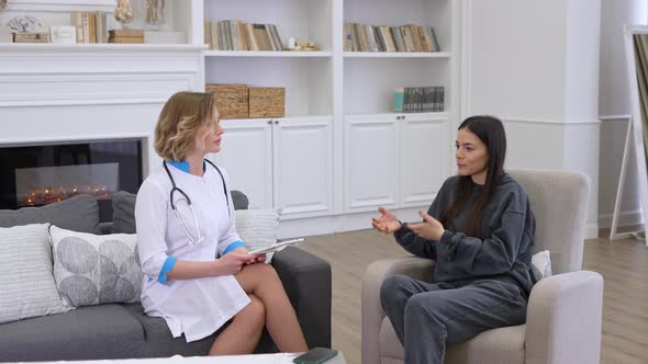 Female Doctor and Patient Saying Goodbye to Each Other After Medical Consultation at Home