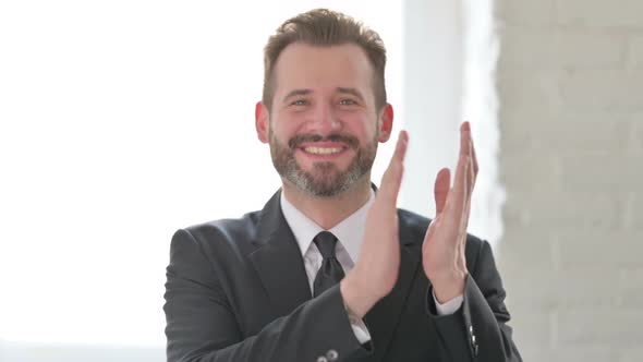 Portrait Shot of Happy Middle Aged Businessman Clapping Applauding