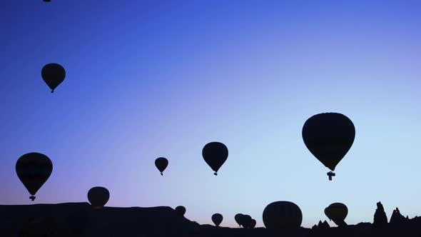 Silhouettes of Hot Air Balloons on Sunset Sky Background