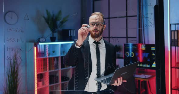 Office Worker Working with Datas on Glass Board and on computer