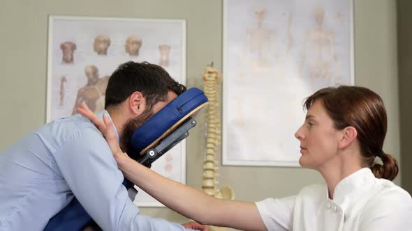 Female physiotherapist giving arm massage to a patient