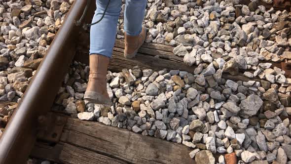 Scene of female walk on old train rails in slow motion  1080p FullHD footage - Casual clothed woman 