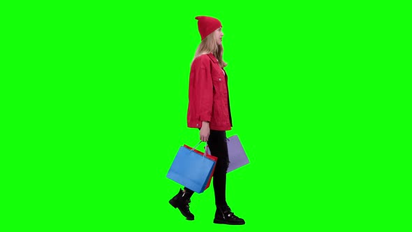 Girl Comes with Bags in His Hands. Green Screen. Slow Motion