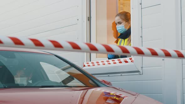 Man in Car Wearing Safety Mask Signing Document at Checkpoint of Private Area