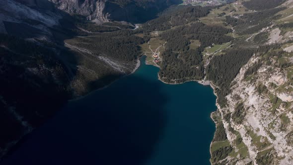 High circling drone shot over blue lake Oeschinen Kandersteg Switzerland