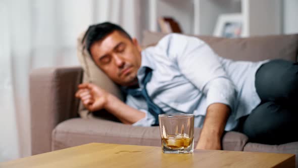 Alcoholic Lying on Sofa and Drinking Whiskey