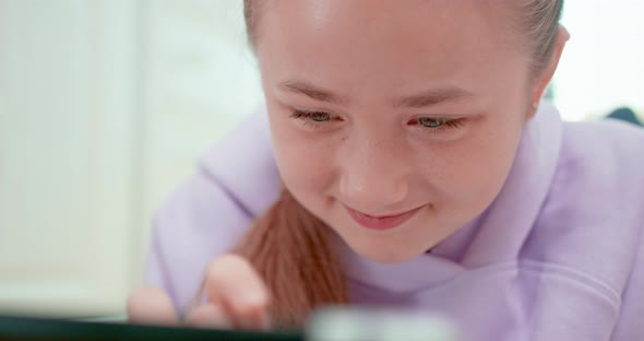 Teen Girl is Smiling When Touches the Tablet