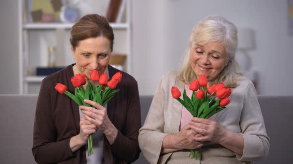 Smiling Elderly Women Sniffing Bouquet of Tulips, Happy Mothers Day, Present