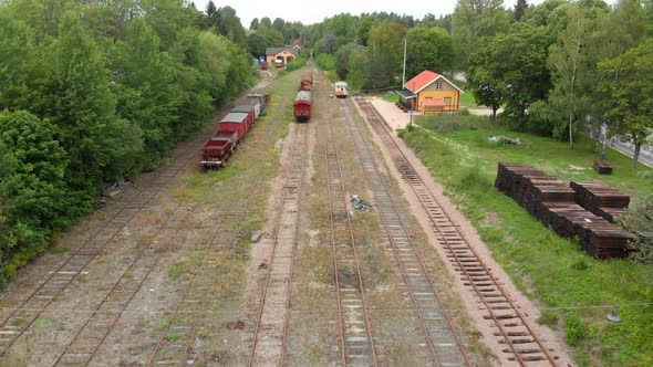 A drone footage of a train station with old train / railcars