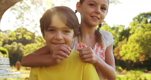 Pretty little girl embracing a little boy alt