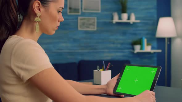 Freelancer Reading Online Book Using Tablet Computer with Mock Up Green Screen Display