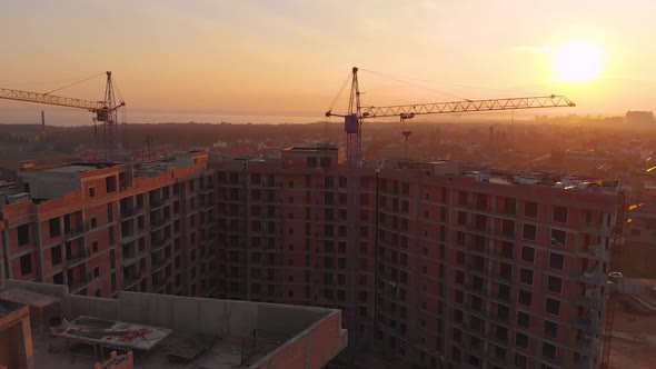 Construction Site in the Middle of the City and Private Houses at Sunset in