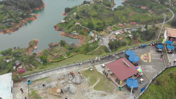 Aerial Over Big Rock With People On At El Peñol In Colombia - drone shot