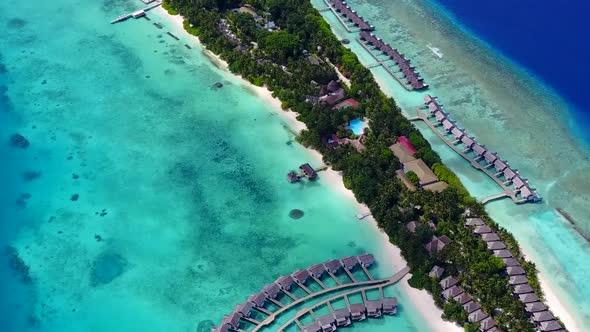 Drone aerial seascape of shore beach trip by blue lagoon with sand background