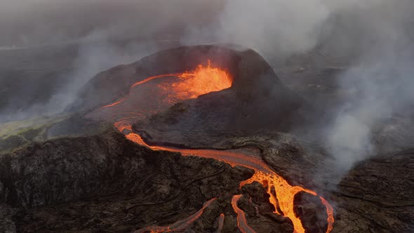 Aerial View Of A Boiling Lava Lake Flowing Down The Volcano With Volcanic Smoke Covering The Sky.