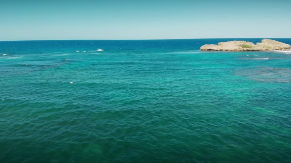 Flight over the sea, lonely little islands near the shore line