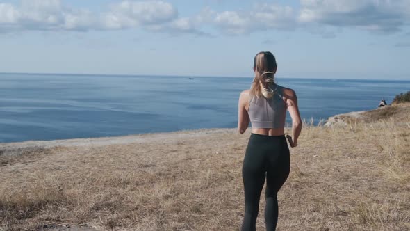 Backside View of Woman Running Outdoors, Beautiful View on Ocean, Slow Motion