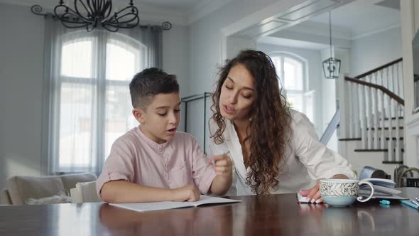 Young Mother And Son At The Table