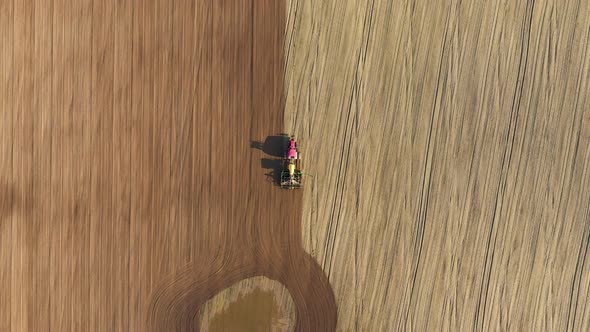 Farmer In Tractor Planting Seeds Of Grain Crops In Agricultural Field In Spring