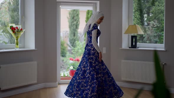 Charming Young Slim Muslim Woman in Hijab and Wedding Dress Spinning Looking at Camera