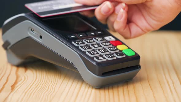 NFC Credit Card Payment. Woman Paying with Contactless Credit Card with NFC Technology. Wireless