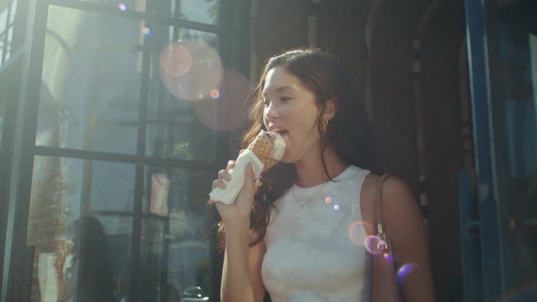 Smiling Woman Enjoying Ice Cream Outdoors