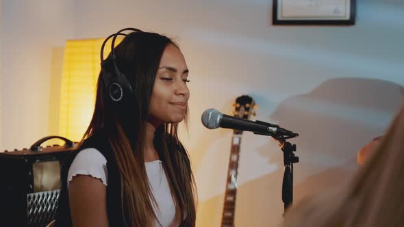 Black Girl in Headphone Singing Into Microphone at the Rehearsal in Home Studio