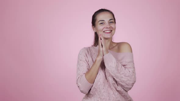 Happy Woman Rejoices Something, Smiles, Claps Hands Isolated on Pink Background