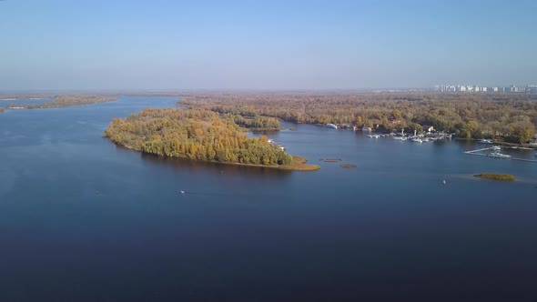 Aerial: Island on Dnipro river in Obolon district of Kiyv, autumn time