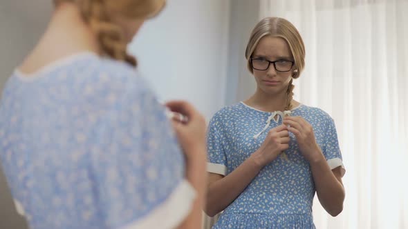 Female Geek in Glasses Looking in the Mirror, Feeling Bad of Poor Appearance