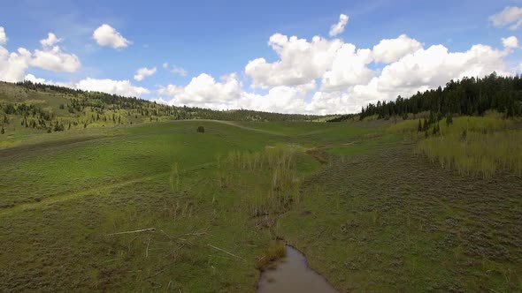 Flying over green hillside in Wyoming landscape