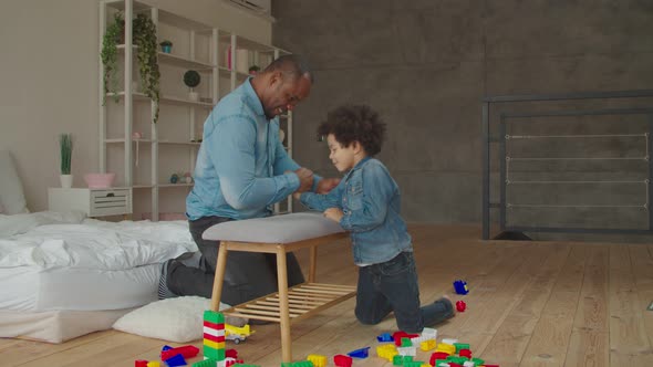 Black Father and Son Competing in Arm Wrestling alt