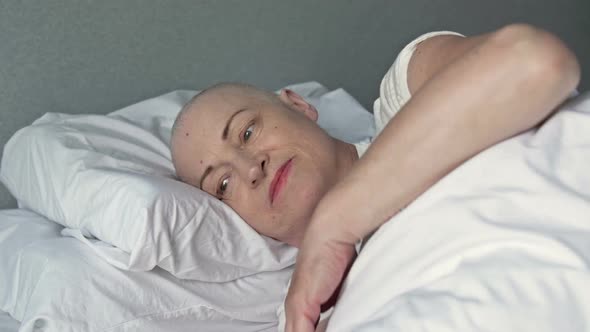 Female Patient Suffering From Cancer Lies in the Patient's Bed After Another Course of Chemotherapy