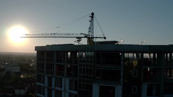 Aerial Drone View of Construction in Sunset Light. Construction Site Building in City. Flying Around