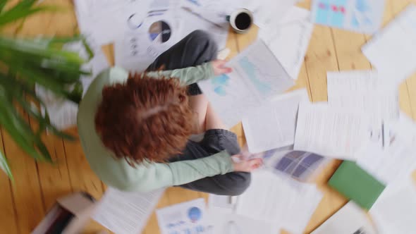 Woman Going through Paperwork while Working from Home