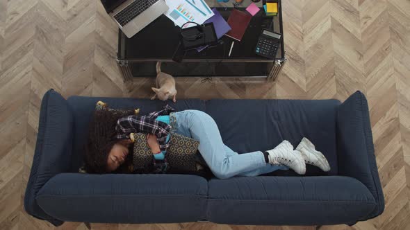 Overhead View of Black Female in Depression on Sofa